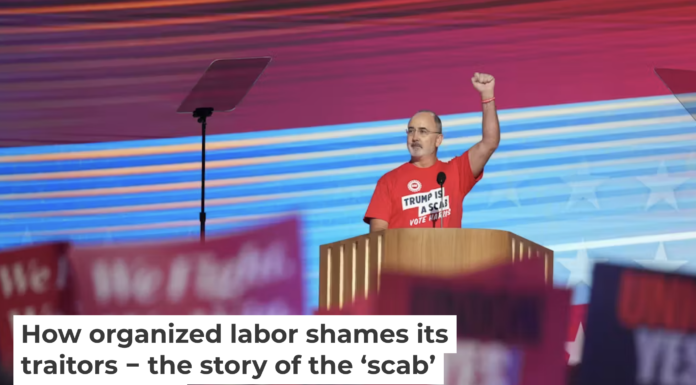 United Auto Workers President Shawn Fain wears a shirt reading ‘Trump is a Scab’ at the Democratic National Convention on Aug. 19, 2024. Andrew Harnik/Getty Images